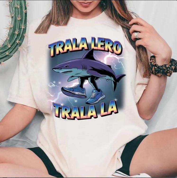 Funny Tralalero Tralala graphic tee, Shark With Shoes Shirt Cotton Fabric Hoodie Sweatshirt | PrintMintTees.com