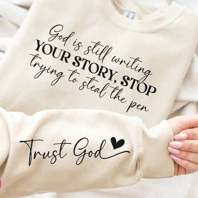 God Is Still Writing Your Story Sweatshirt - Front & Hand, Funny Christian Shirt, Faith Shirt Hoodie | PrintMintTees.com