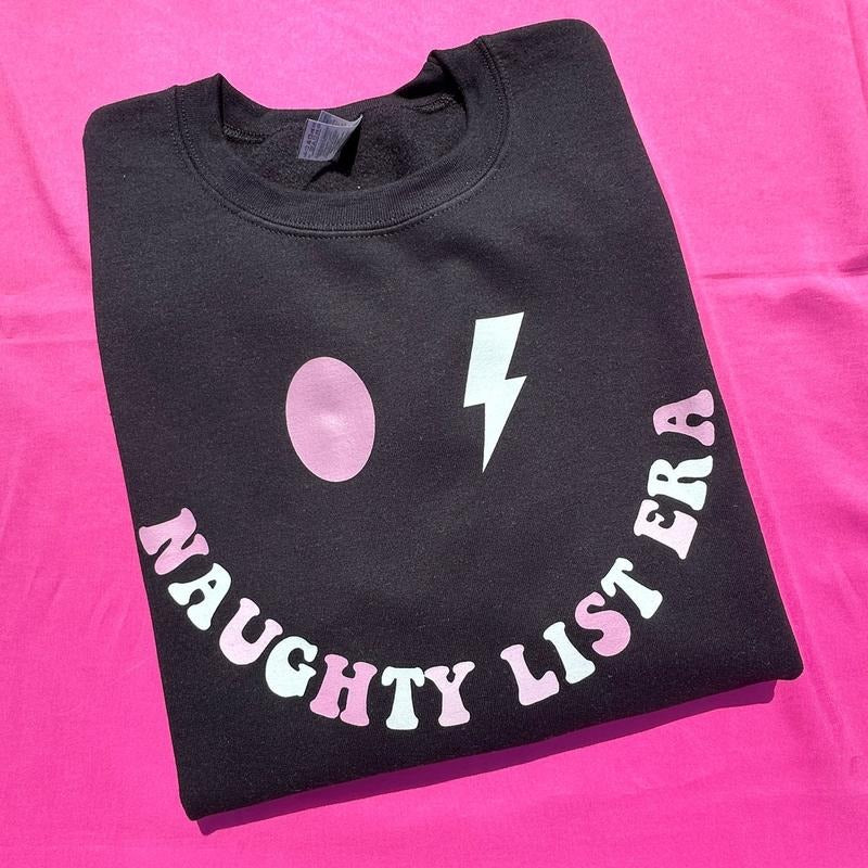 Naughty List Era Sweatshirt 'NLB' T-Shirts, Hoodie | PrintMintTees.com