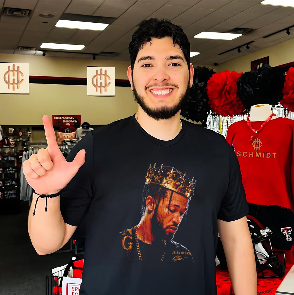 New York Knicks Jalen Brunson wearing gold crown shirt