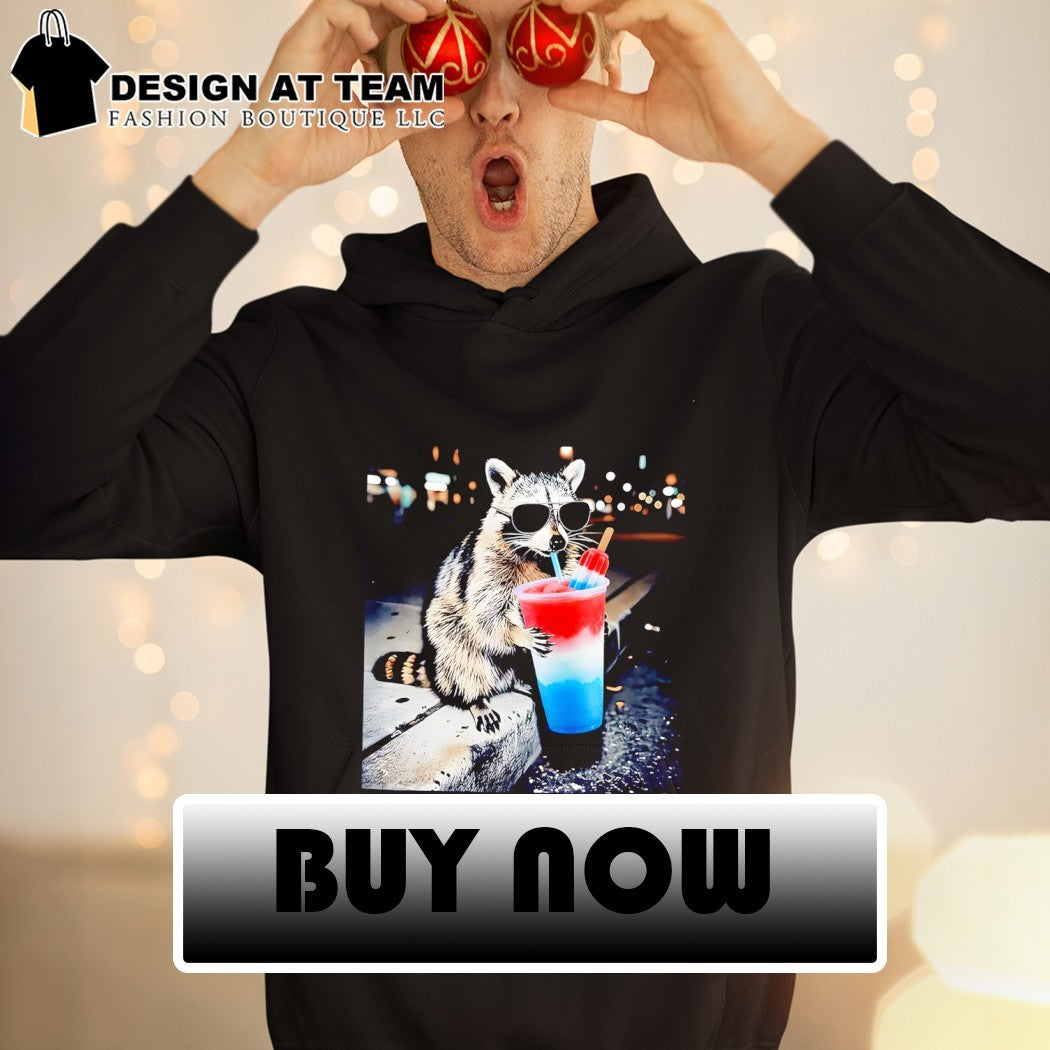 Raccoon holding a red white and blue slushy with popsicle shirt