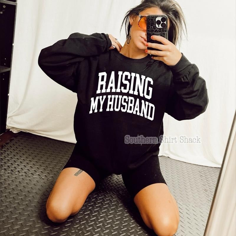 Raising my Husband Sweatshirt | Black Sweatshirt graphic shirt unisex style Hoodie | PrintMintTees.com