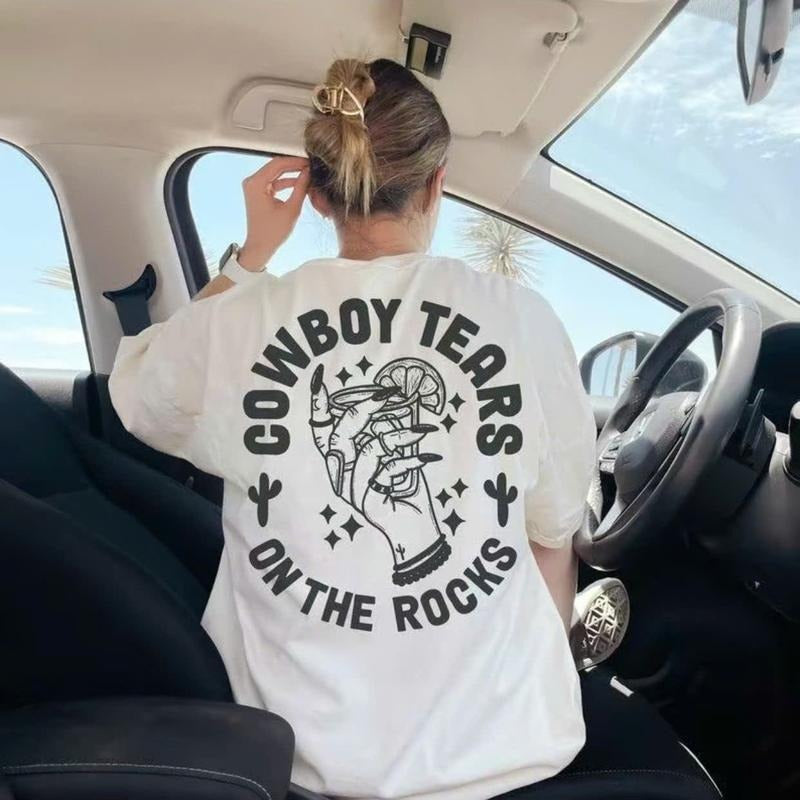 Trendy T - Shirt Featuring "Cowboy Tears on the Rocks" Graphic, Ideal for Fashion