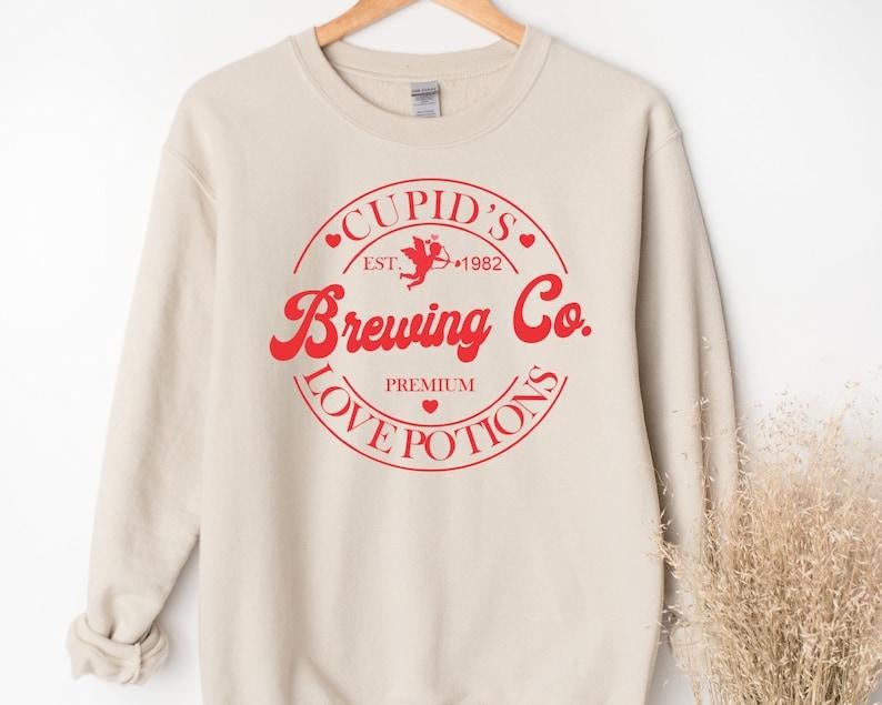 Valentines Day Sweatshirt, Cupid's Brewing Co Premium Love Potions Est 1982, Cute Valentines  Hoodie and Sweater; T-shirt...
