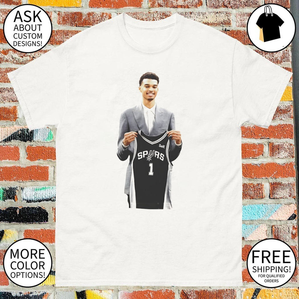 Victor Wembanyama is holding 1 jersey for the San Antonio Spurs Basketball NBA 2026 shirt