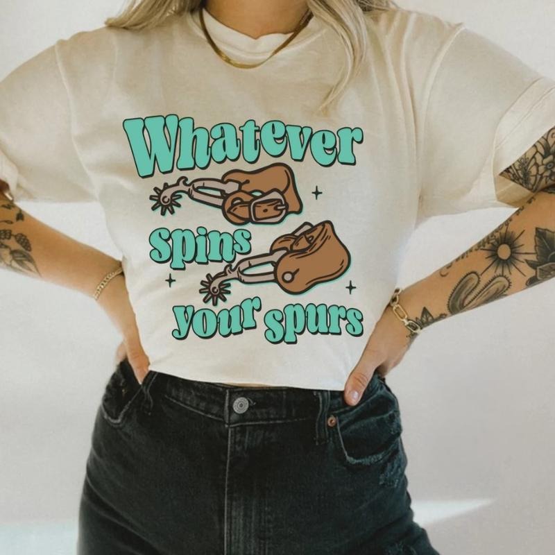 What Spins Your Spurs Tee, graphic tees women, western outfits women, western tops clothing, rodeo cowgirl outfits women,...
