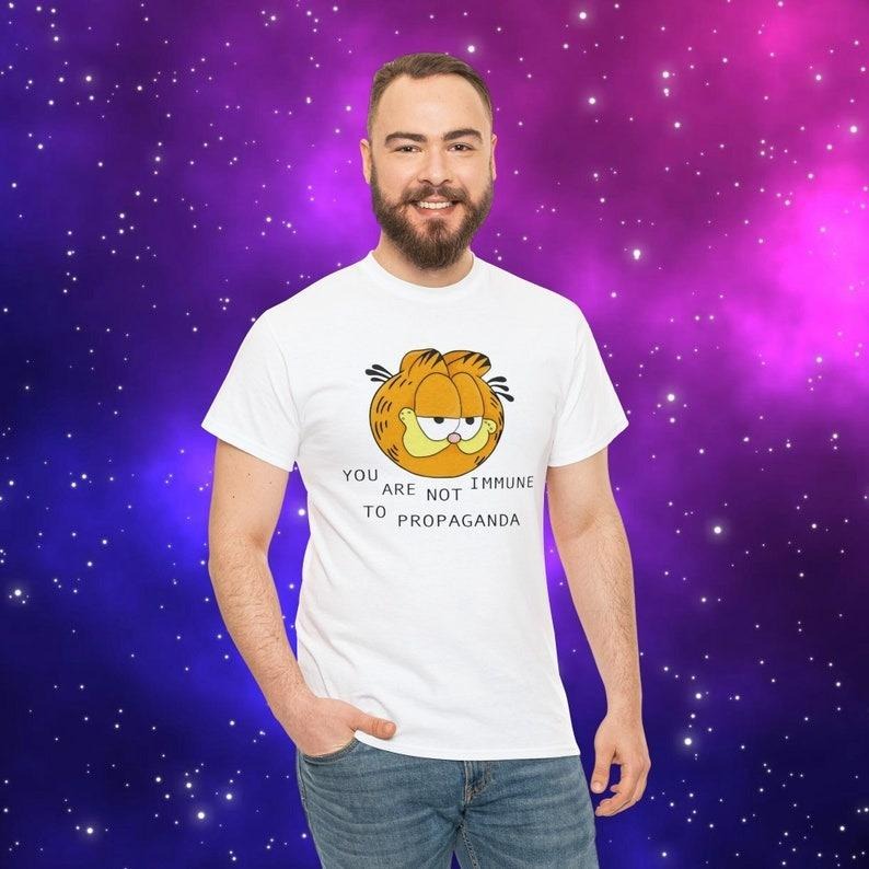 You Are Not Immune To Propaganda Shirt | Garfield You Are Not immune to Propaganda shirt Hoodie Sweatshirt