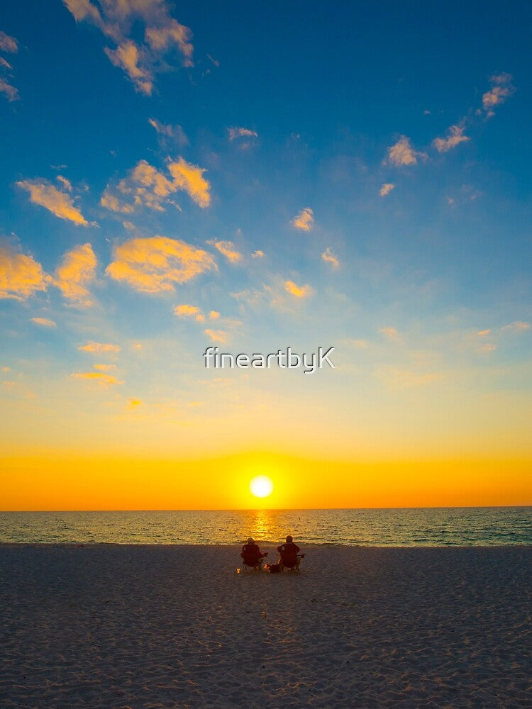 couple watching sunset at the beach by fineartbyK